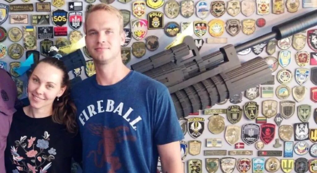 Click to enlarge Craig Lang poses in front of the same wall as Paul Gray.