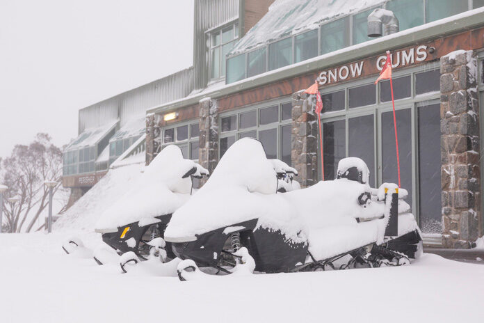 Click to enlarge Snowmobiles all but swallowed up at Perisher, where 20cm fell in less than 24 hours.