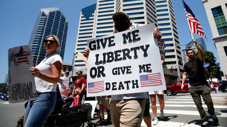 Click to enlarge Demonstrators in San Diego are shown protesting California's Covid-19 lockdown in May 2020.