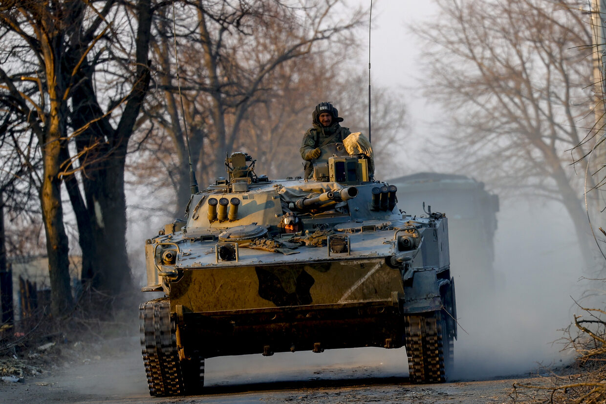 Click to enlarge Russian military vehicles patrol in Volnovakha city.