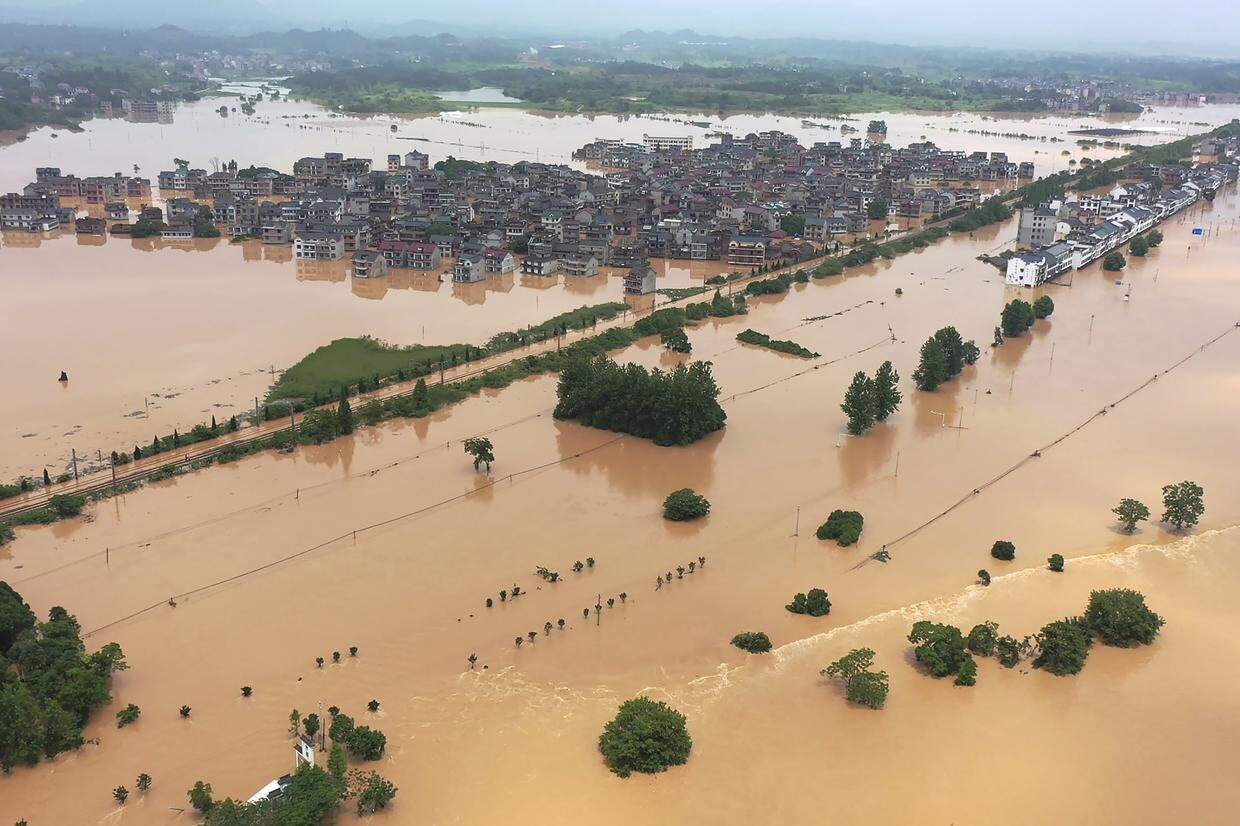Floodwaters flow around a town in Shangrao in central China’s Jiangxi province