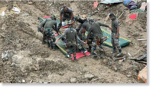 Soldiers carry the body of a victim during rescue efforts after the landslide