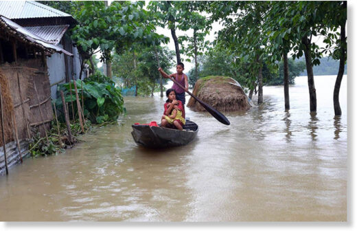 Children use a boat for transportation in a flooded area in Sunamganj on June 21, 2022