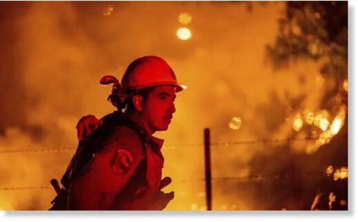 Click to enlarge Rafael Soto battles the Electra fire burning in the Rich Gulch community of Calaveras County, California, on Tuesday.