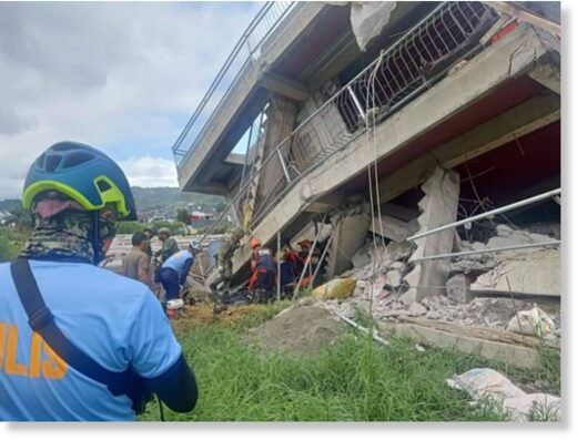 Click to enlarge Rescuers and policemen retrieve a resident from a collapsed building following an earthquake in the northern Philippines