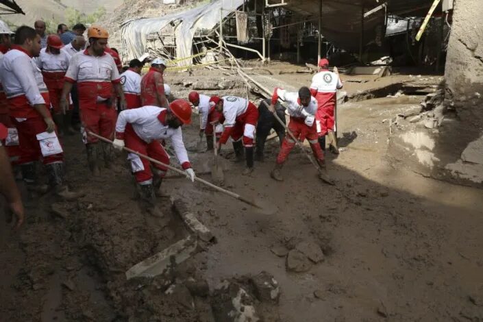 In Imamzadeh Davood village, north of Tehran, rescue workers dig through mud after flash flooding.