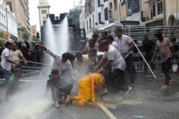 Click to enlarge Police use water cannons to disperse farmers