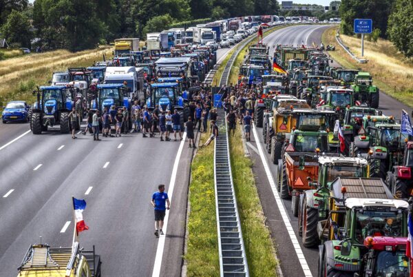 Click to enlarge Farmers gather with their vehicles next to a Germany/Netherlands border