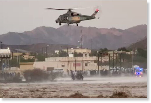 An Oman Police helicopter evacuates people stuck in the floods.