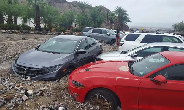 Cars are stuck in mud and debris from flash flooding at The Inn at Death Valley in Death Valley National Park.