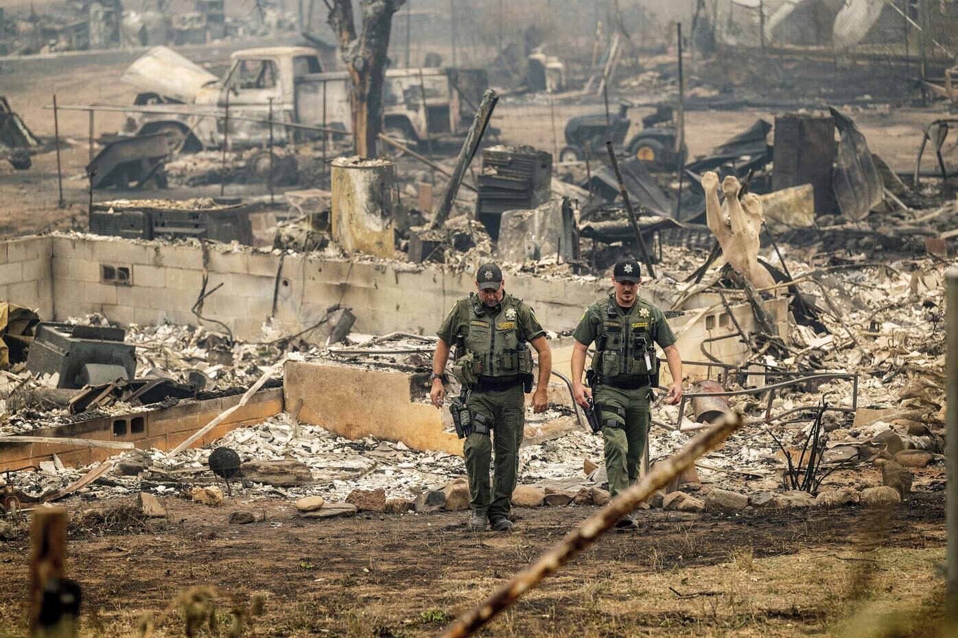 Sheriff's deputies leave a home where a body was found.