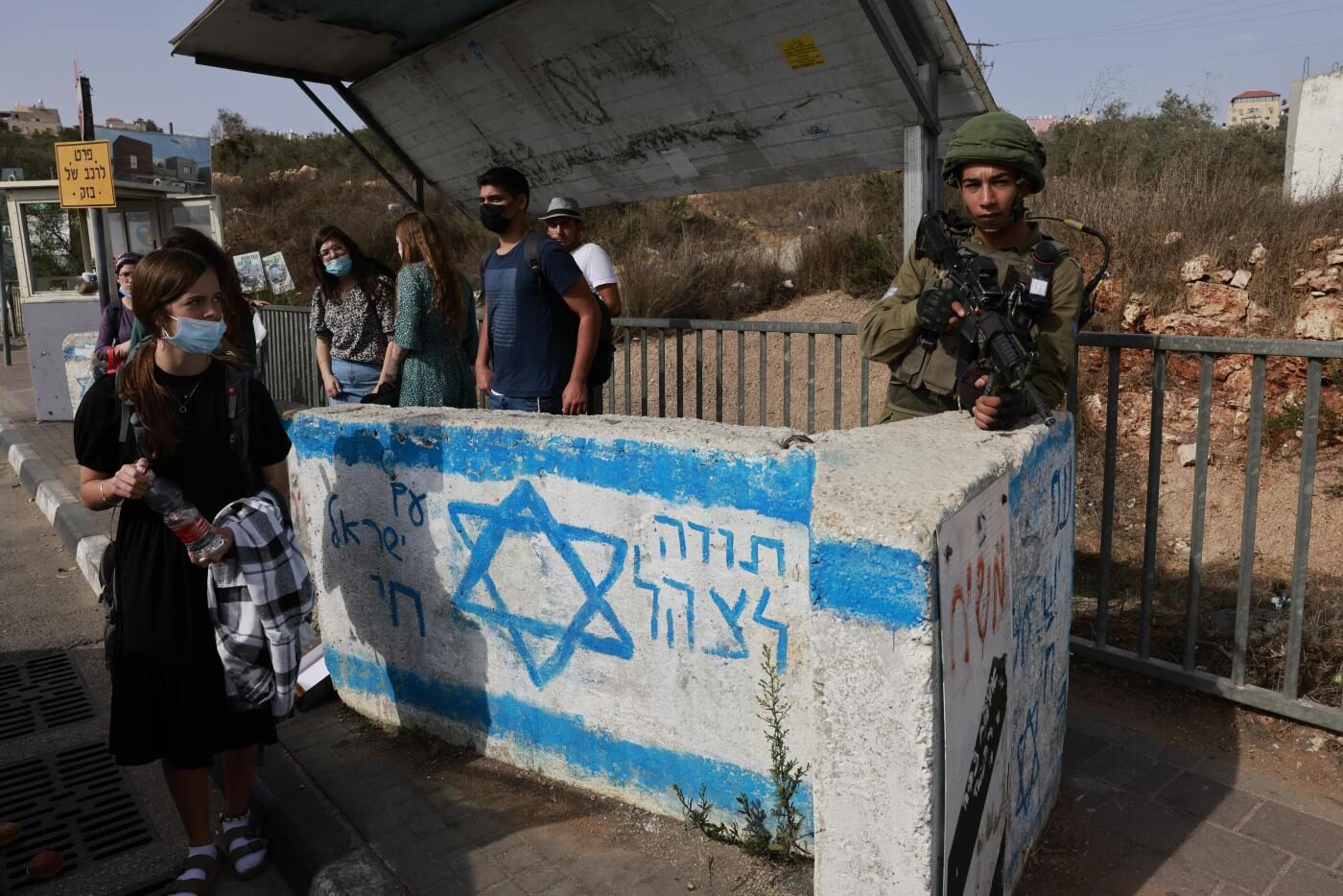Click to enlarge bus station west bank israel soldier apartheid