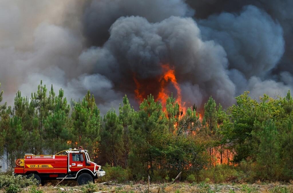 Click to enlarge A firefighting truck works to contain a fire in Saint-Magne, as wildfires continue to spread in the Gironde region of southwestern France, August 11, 2022.
