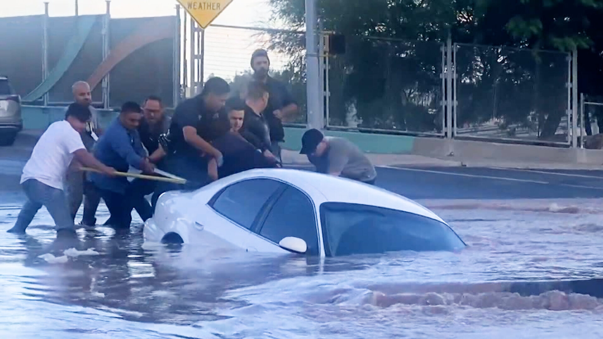 Watch dramatic rescue as car gets sucked into sinkhole