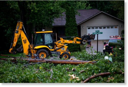 Fallen tree limbs are cleared after thunderstorms and high winds downed power lines and closed roads in Holland, Michigan, U.S. August 29, 2022.