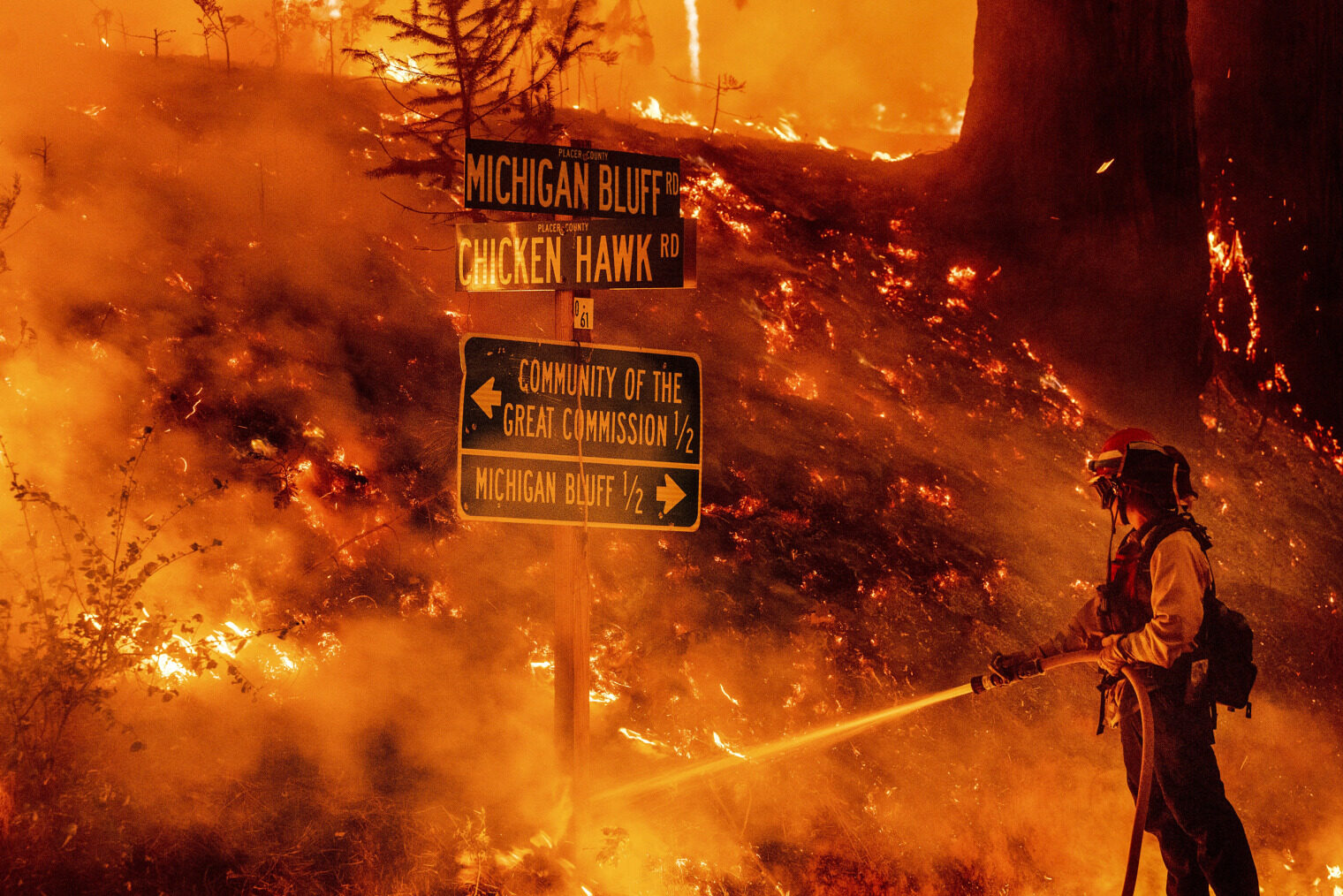 Click to enlarge A firefighter battles the Mosquito Fire in Placer County, Calif., on Wednesday.