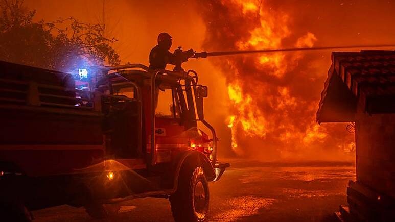 The blazes have forced the evacuation of residents amid record temperatures for September.