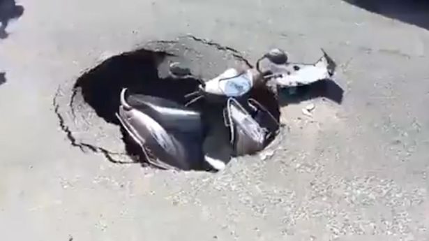 The little scooter was stuck inside the hole