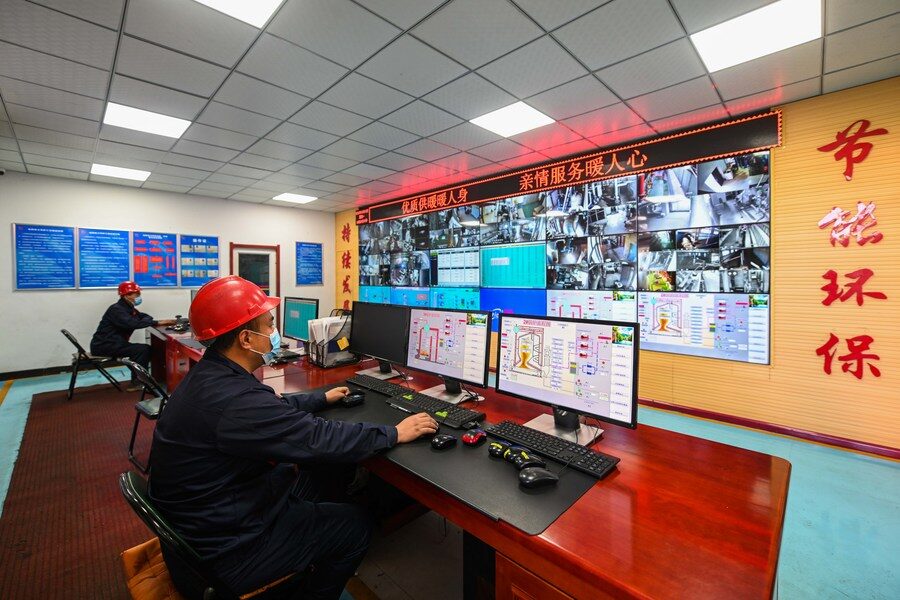 Workers monitor the operation of boilers at a heating company in Hohhot, north China's Inner Mongolia Autonomous Region, Oct. 10, 2022.