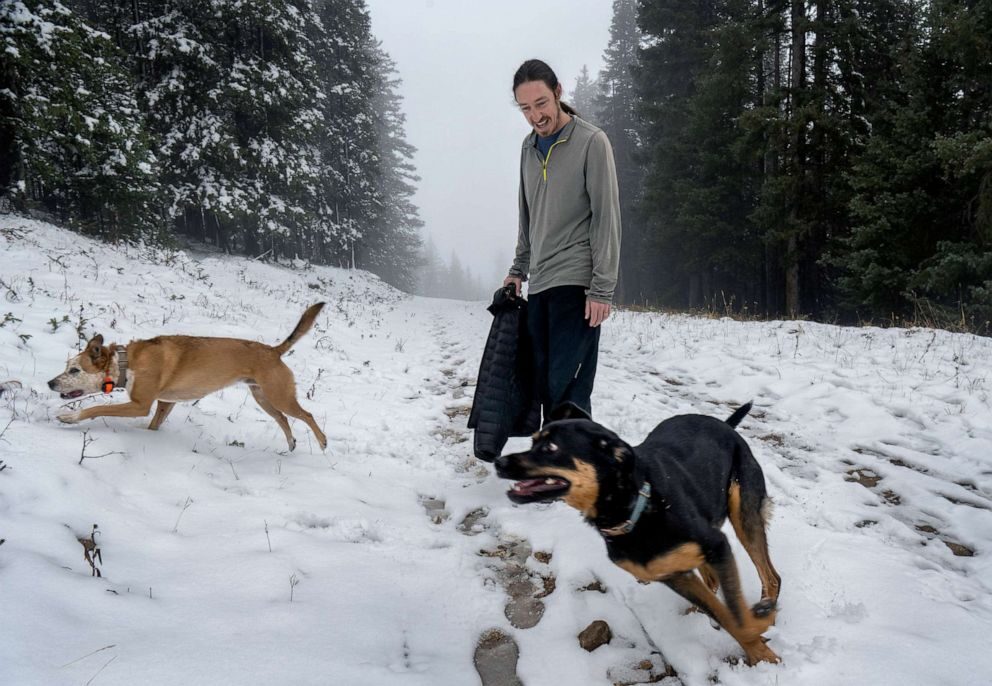 Click to enlarge Chris Dugan, from Santa Fe, plays with his dogs at the Ski Santa Fe, on Oct. 17, 2022, in Sante Fe, N.M.