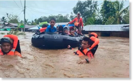 Philippine rescuers evacuate people from floods from Severe Tropical Storm Nalgae in Parang, Maguindanao province.