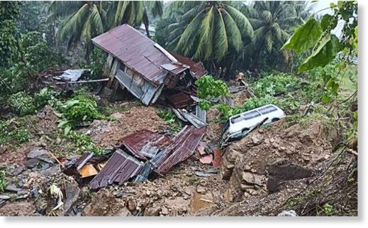 A resident beside a damaged house and vehicle after a landslide in Parang town in Maguindanao province, southern Philippines.