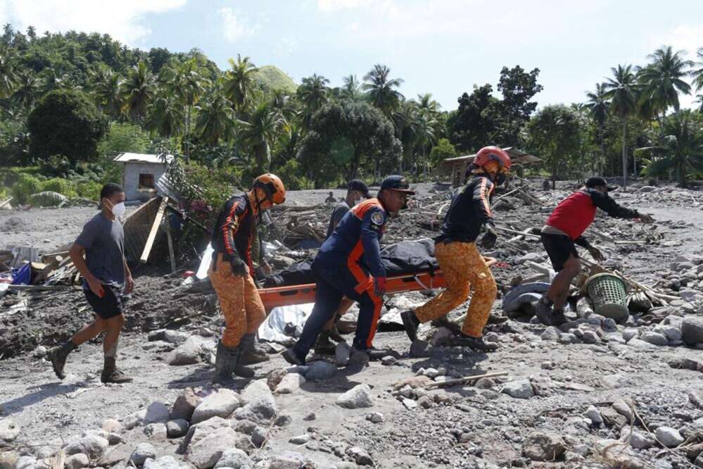 Rescuers carry a body at Maguindanao's Datu Odin Sinsuat town, southern Philippines on Sunday October 30, 2022.