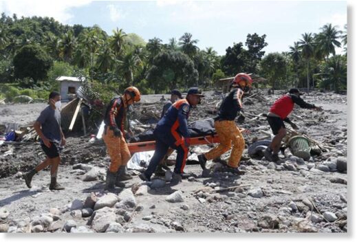 Rescuers carry a body at Maguindanao's Datu Odin Sinsuat town, southern Philippines on Sunday October 30, 2022.