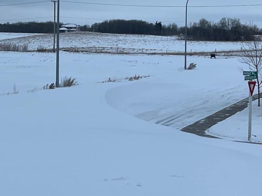 Click to enlarge A street in the Crescent Acres neighbourhood of Prince Albert that saw snow drifts as high as street signs.