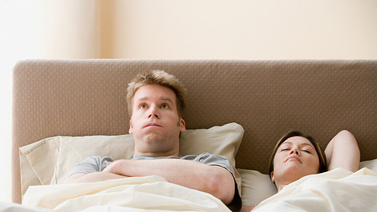 man and woman in bed, lazy, exasperated, tired