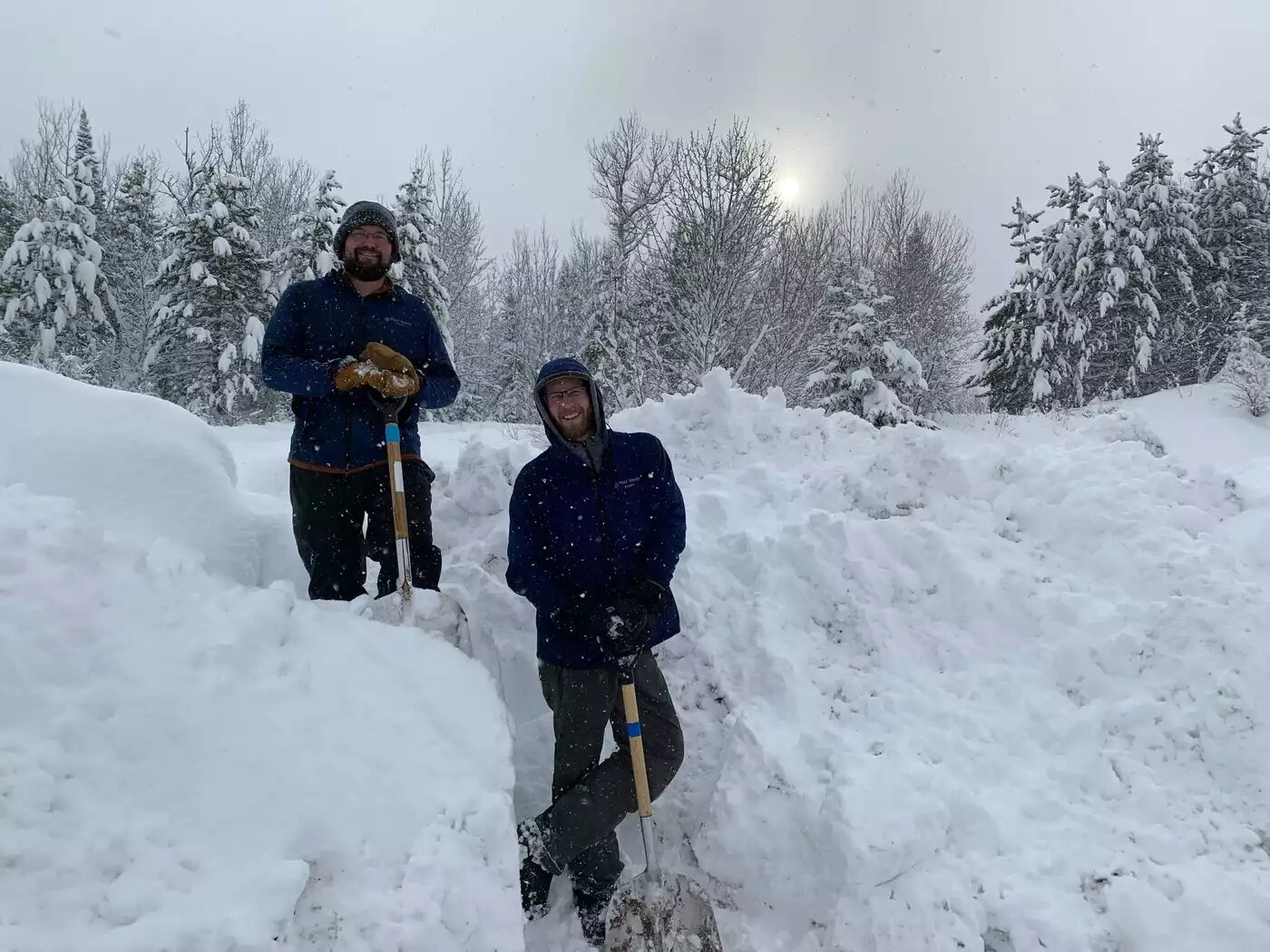 David Stieler (left) and Charlie Pavlisich pose for a photo after shoveling snow at Wolf Ridge Environmental Learning Center in Finland, Minn. on Wednesday.