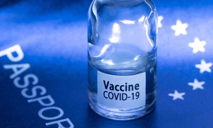 Click to enlarge A vaccine vial on a European passport in Paris