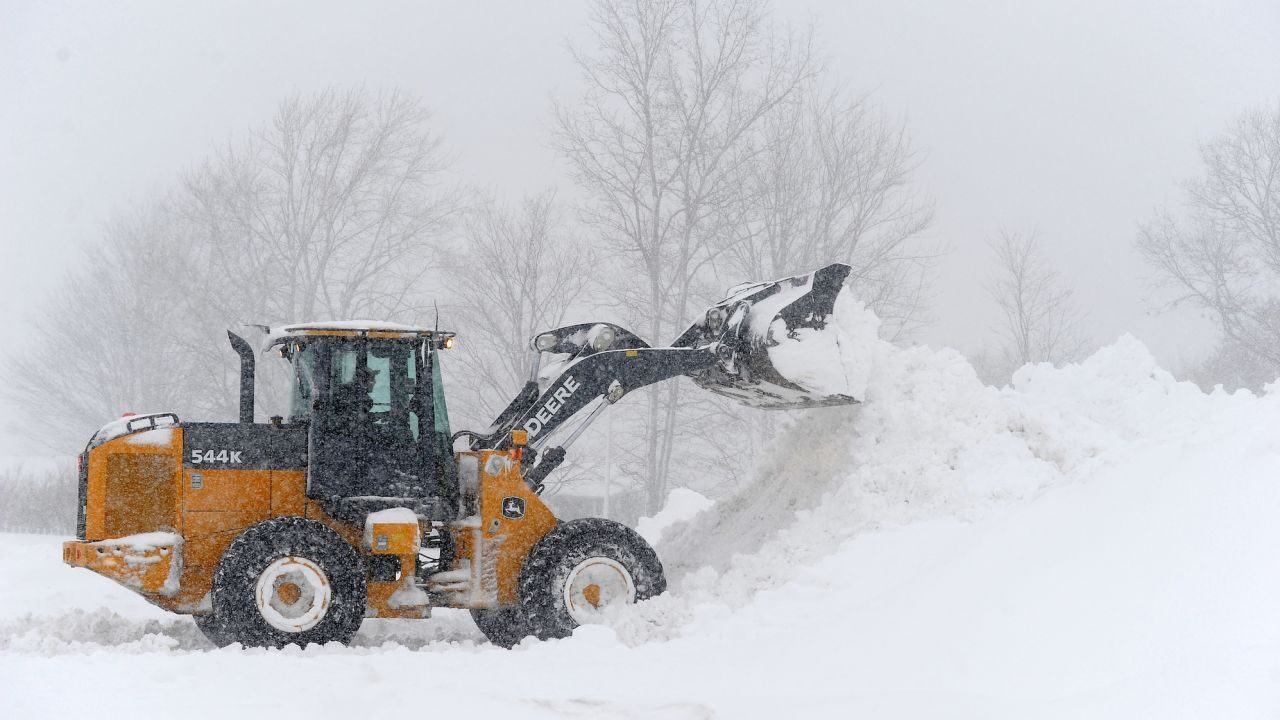 A loader on Friday digs out a parking lot in Hamburg, New York, after an intense lake effect snow storm dumped several feet of snow around Buffalo and surrounding suburbs.