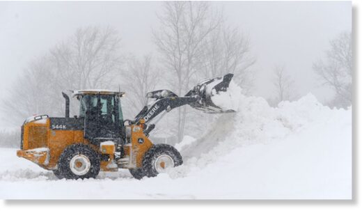 A loader on Friday digs out a parking lot in Hamburg, New York, after an intense lake effect snow storm dumped several feet of snow around Buffalo and surrounding suburbs.