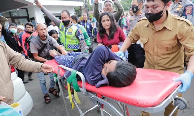 Rescuers carry an injured victim of the earthquake at a hospital in Cianjur, Indonesia.