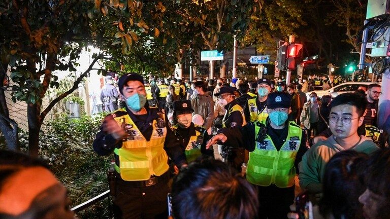 Click to enlarge Police officers disperse a protest in Shanghai, China