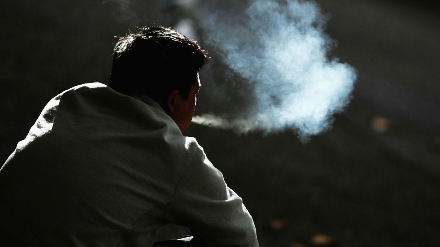 man smoking cigarettes