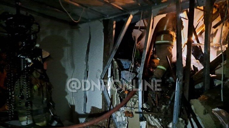 Click to enlarge Firefighters pictured inside a building in Donetsk damaged by Ukrainian shelling.