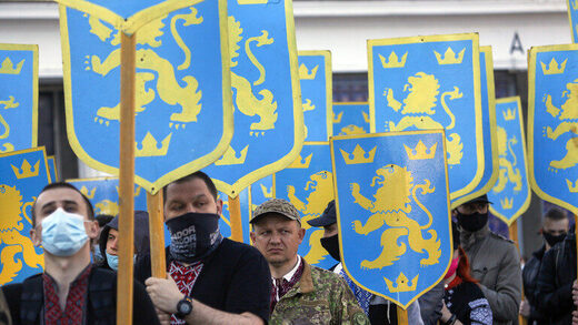 Ukrainian nationalists carry emblems of the SS Galicia Division