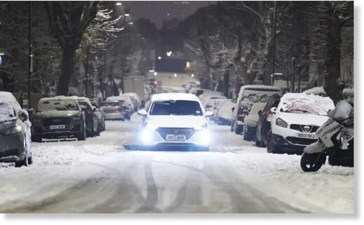 Click to enlarge A car drives along a snow-covered road in the early morning at Willesden Green, north-west London.