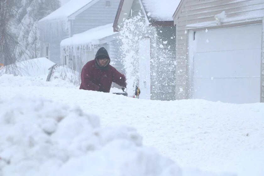 A Proctor resident uses a snowblower
