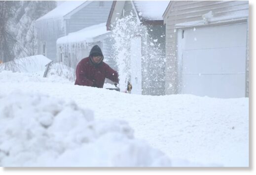 A Proctor resident uses a snowblower
