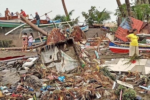 This handout photo courtesy of Angelica Villarta taken on December 27, 2022 and received on December 28 shows residents surveying damage caused by heavy rain and floods in Oroquieta City, Misamis Occidental.
