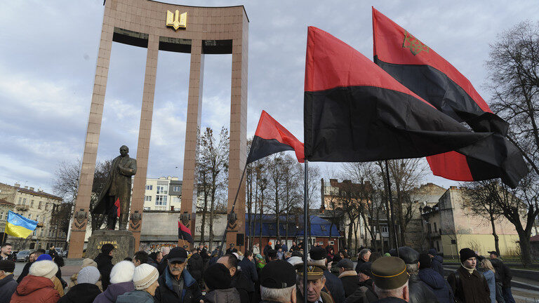 Click to enlarge Demonstrators gather at the monument to Stepan Bandera in Lviv