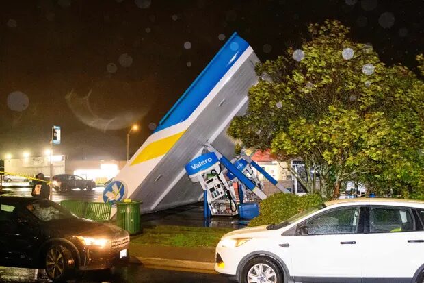 Click to enlarge A damaged Valero gas station creaks in the wind during a ‘bomb cyclone’ rain storm in south San Francisco on 4 January.