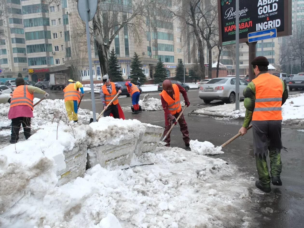 Click to enlarge Utility workers in Almaty, Kazakhstan, clearing away snow on the street last week.