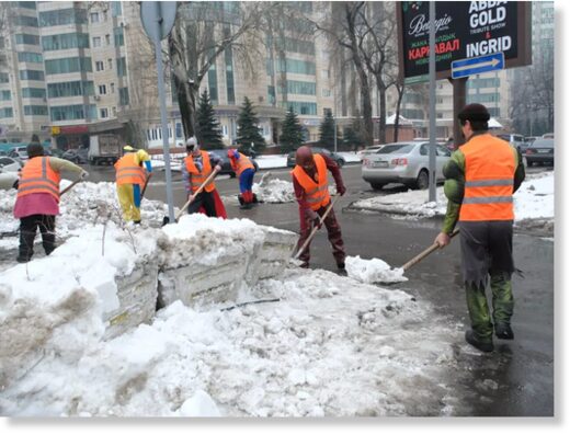 Click to enlarge Utility workers in Almaty, Kazakhstan, clearing away snow on the street last week.