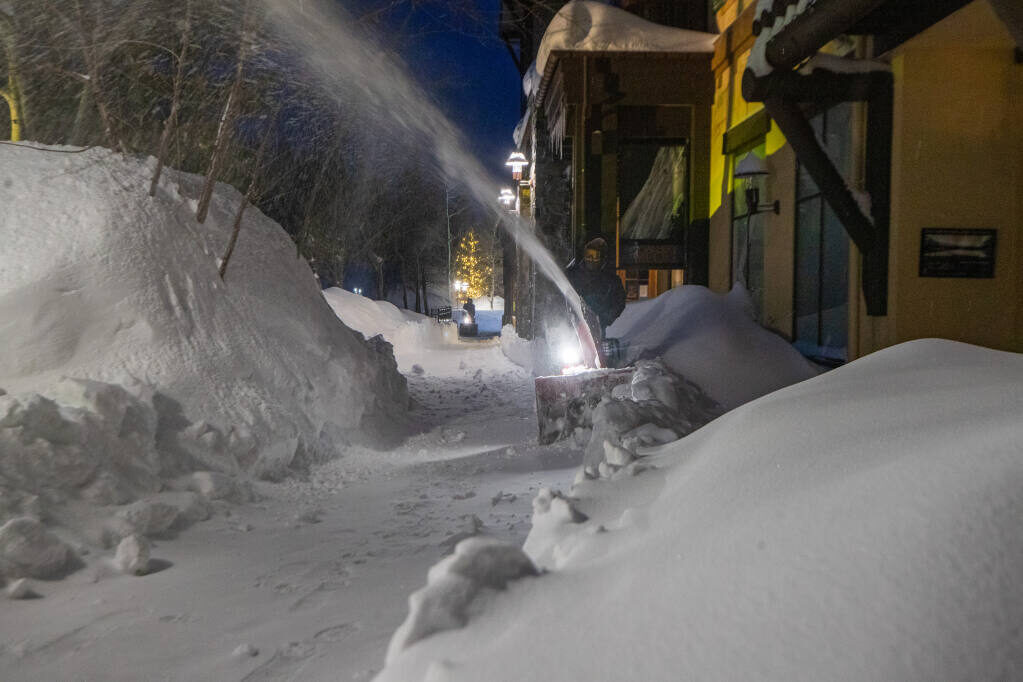 Crews plow snow at Palisades Tahoe in Olympic Valley in the early morning hours Wednesday, Jan. 11, 2023.