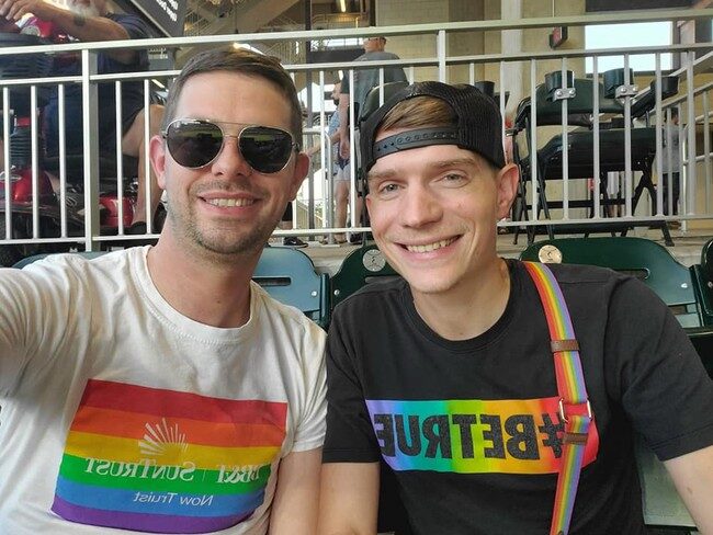 Zachary (left) in his rainbow-colored SunTrust T-shirt
