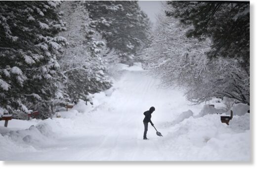 Click to enlarge In the middle of a series of winter storms that brought more than 20 inches of snow to Flagstaff in 48 hours, a woman digs out her driveway Monday morning as snow continues to fall.